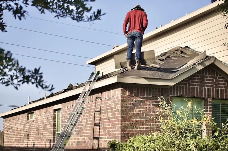 Professional roofer working on a residential roof in Chippewa Park